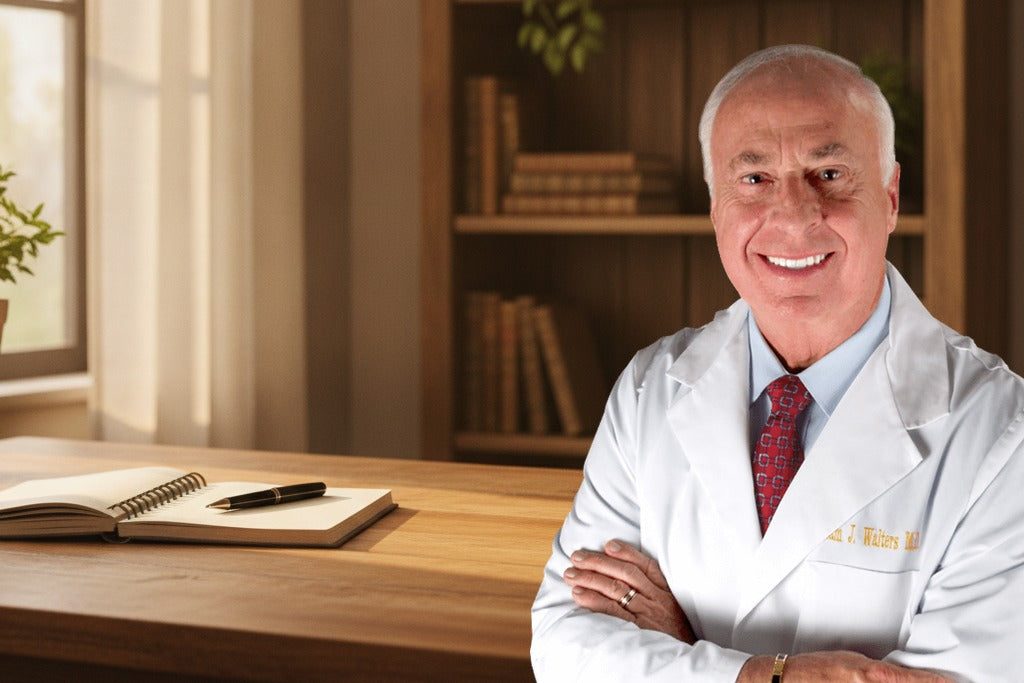 Dr. Sam Walters, NMD, at a wooden desk in a home office